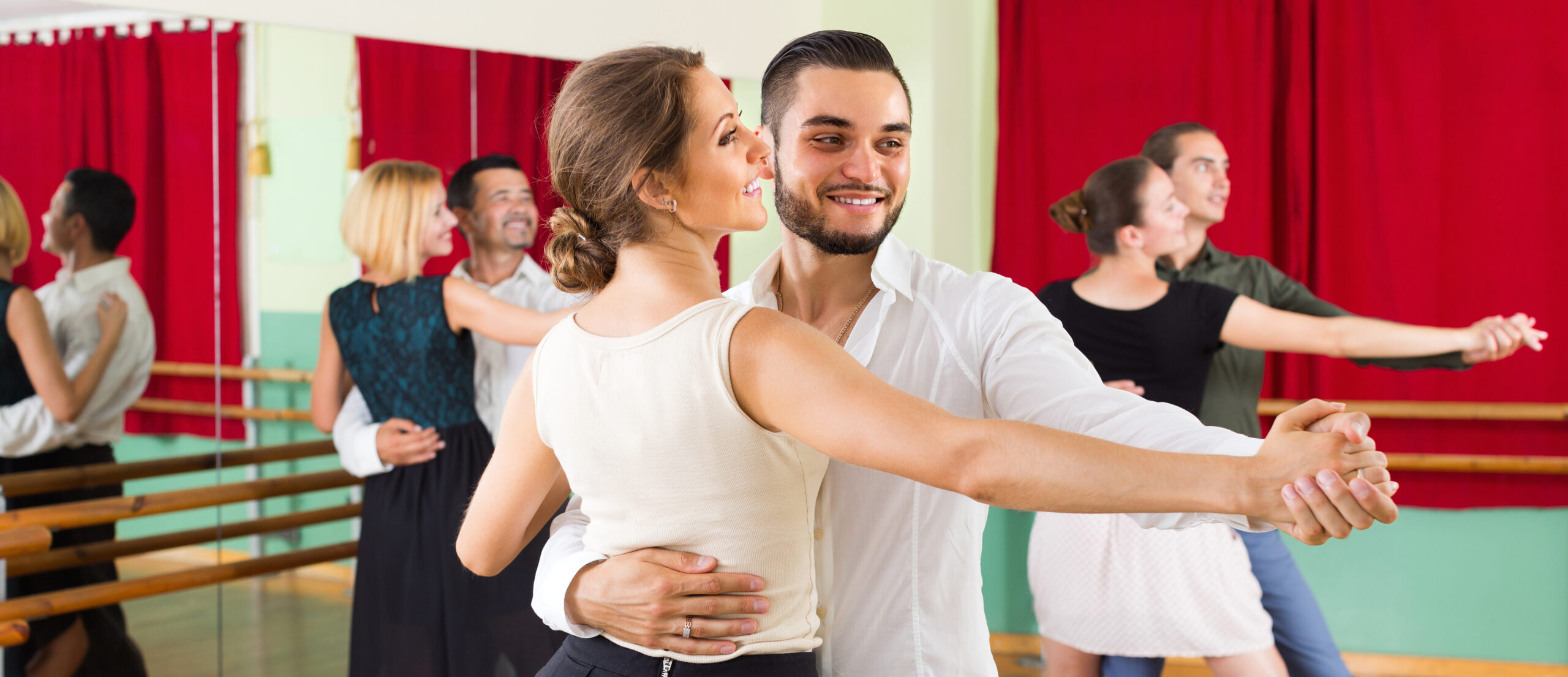 young couple ballroom dancing in studio